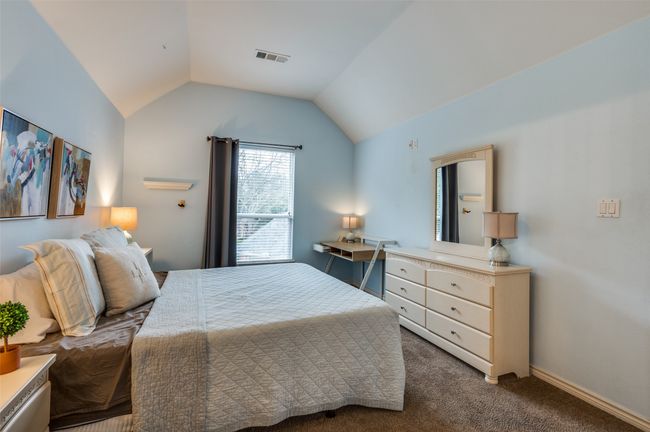 Carpeted bedroom featuring lofted ceiling | Image 17