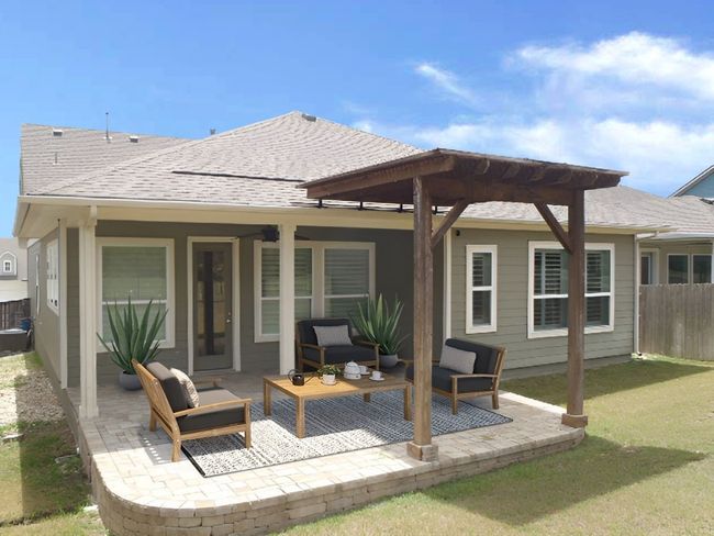 Rear view of property featuring a patio area, an outdoor living space, and a shingled roof | Image 8
