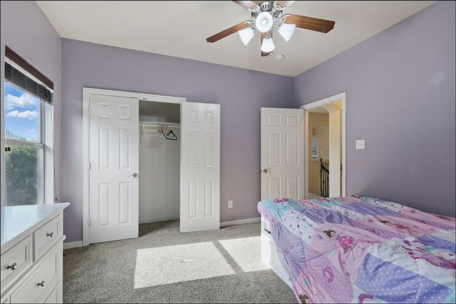 Bedroom with arched walkways, light carpet, a ceiling fan, and ensuite bathroom | Image 29