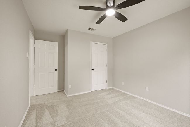 All of the bedrooms are spacious with large windows, fresh carpet, and modern ceiling fans. | Image 35