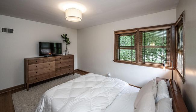 Owner's bedroom features hardwood floors & lots of windows | Image 13