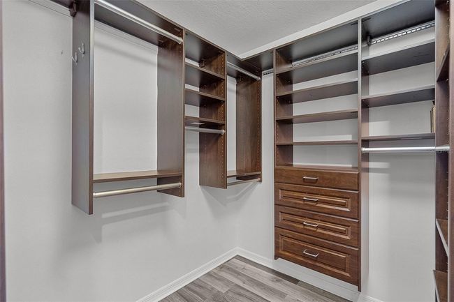 Walk in closet in the primary bedroom with custom built ins | Image 15