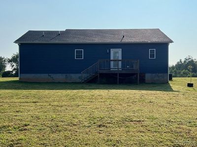 Rear view of house with a wooden deck and a yard | Image 3