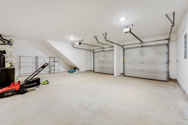 Garage with a garage door opener and water heater | Image 40