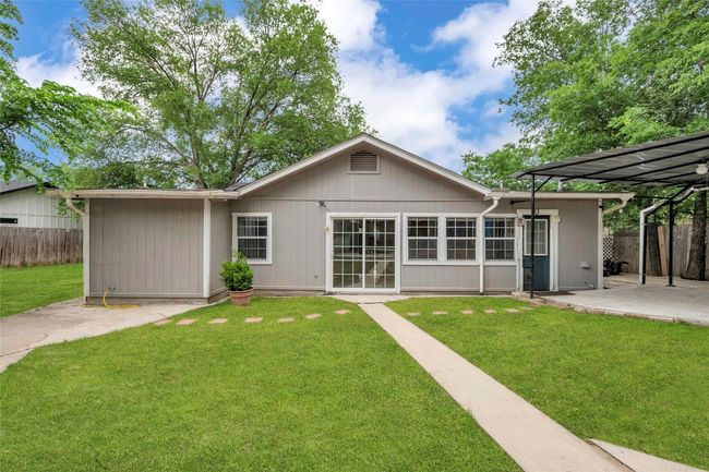 Rear view of property with fence, a yard, and a patio area | Image 8