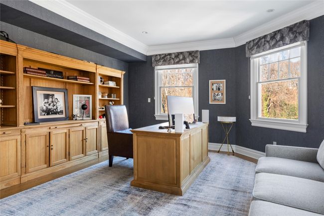 Office area featuring light wood finished floors, crown molding, and baseboards | Image 15