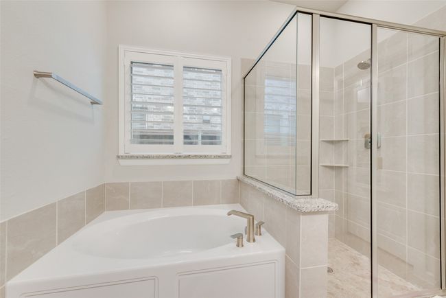 Bathroom featuring a shower stall and a garden tub | Image 18