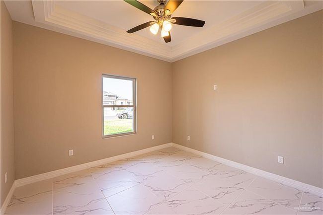 Unfurnished room featuring a raised ceiling and marble finish floor | Image 17