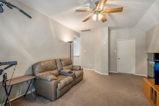 Looking back towards the entrance to the game room, you'll notice a doorway leading to attic storage, while on the left, an open doorway offers access back to the upstairs landing, creating a seamless connection between the spaces. | Image 27