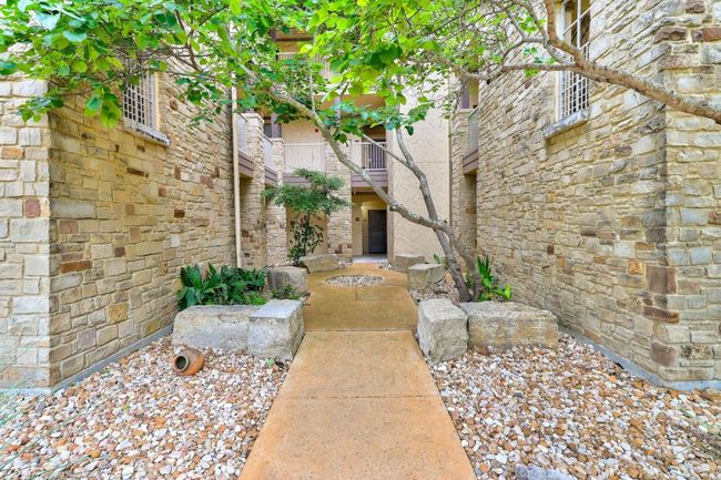 Doorway to property featuring stone siding | Image 4