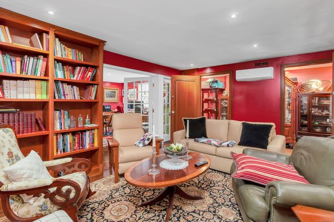 There are many built-ins and bookcases, and a custom entertainment center. | Image 12