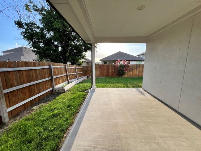 Fenced backyard with a patio area | Image 12
