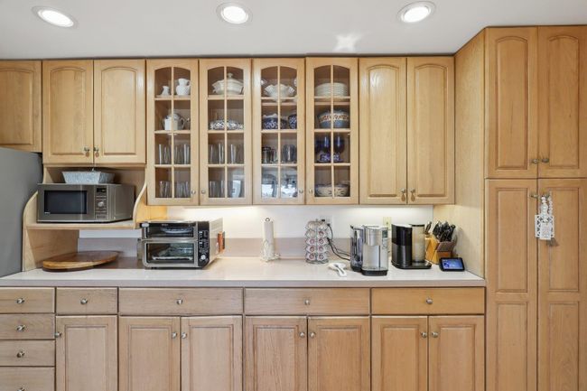 Kitchen with stainless steel microwave, recessed lighting, and light countertops | Image 16