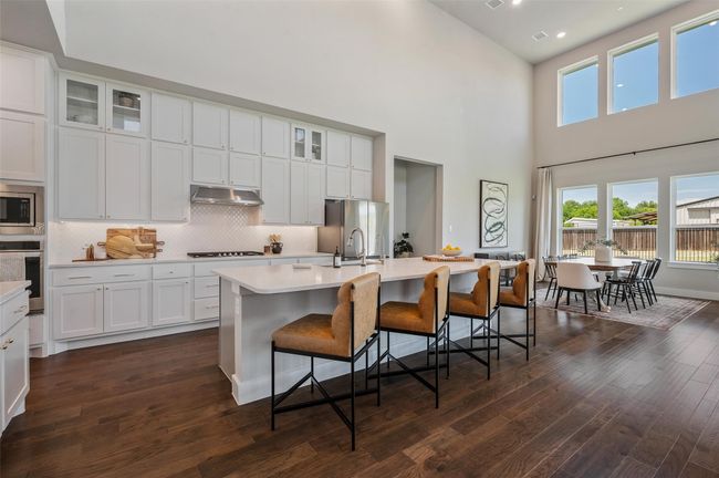 Large open kitchen with beautiful cabinetry including some upper display cabinets. | Image 7