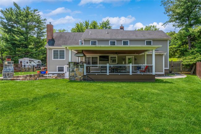 Back of house with a chimney and a deck | Image 22