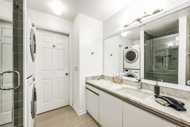 In-unit laundry in hall bathroom. | Image 26