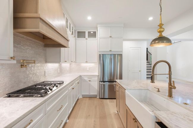 Gorgeous brushed gold fixtures and accents grace this lovely kitchen. | Image 10