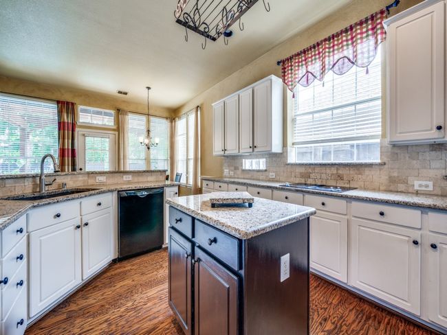 Kitchen with finished floors, and white cabinetry | Image 13