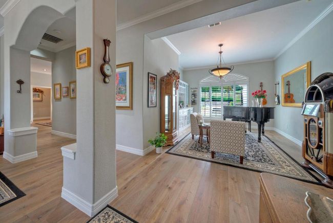 Entrance foyer with ornamental molding, visible vents, and light wood-style flooring | Image 5