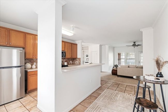 The kitchen is complete with a serving/breakfast bar. | Image 12