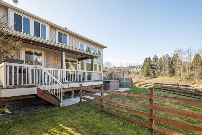 View of property exterior with a yard, fence, and a trampoline | Image 39