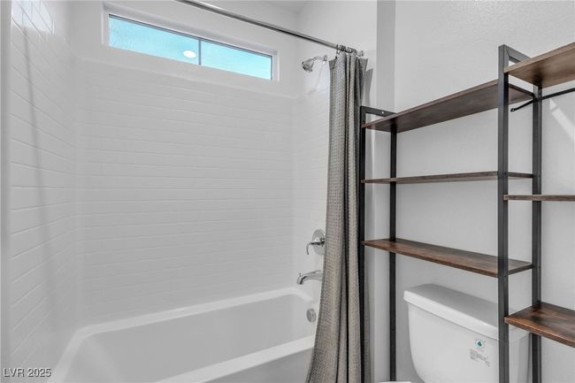 Full bathroom featuring shower / bath combo and toilet | Image 17