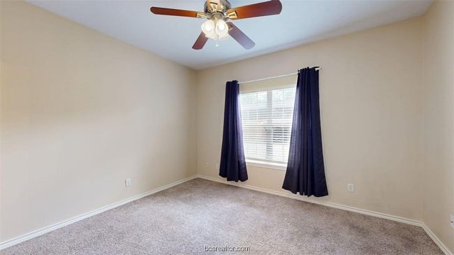 Spare room with a ceiling fan, carpet, and baseboards | Image 19