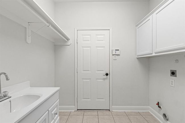 There's a sink in the laundry room and room for a second fridge. | Image 29
