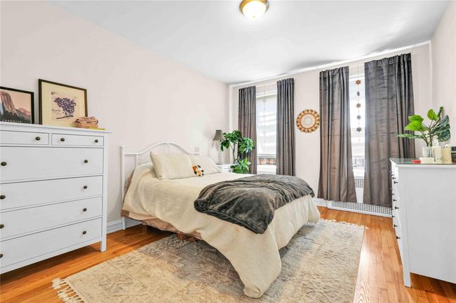 Bedroom featuring light wood-style flooring | Image 10
