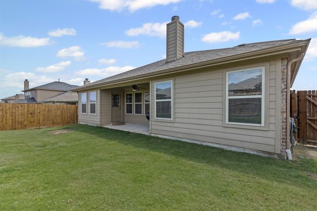 Back of property featuring a fenced backyard, a chimney, a ceiling fan, and a patio | Image 30