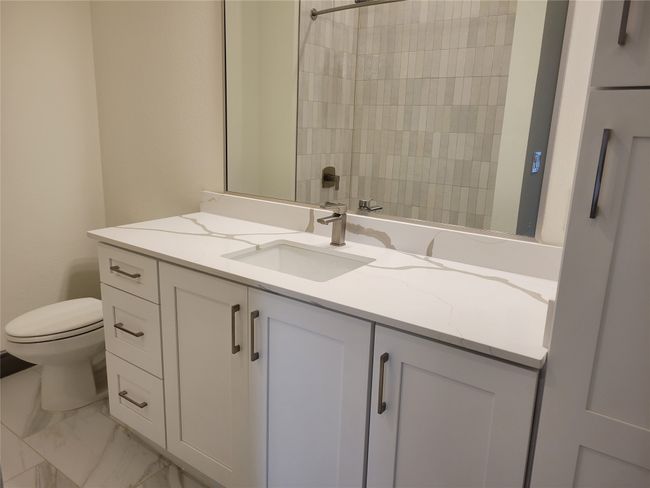 Full bathroom with vanity, marble finish flooring, and a shower | Image 16