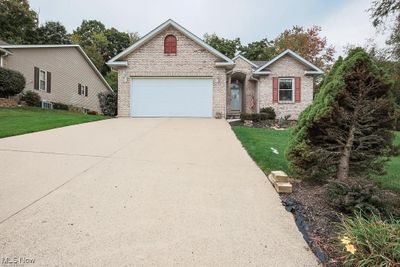 View of front of property with a garage and a front yard | Image 1