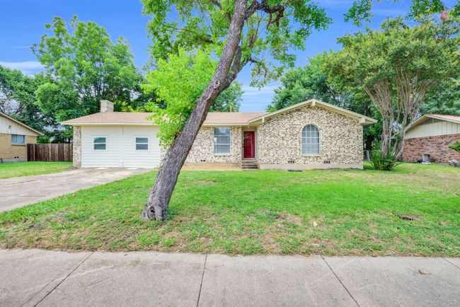 Ranch-style home featuring brick siding and driveway | Image 4