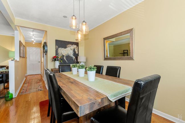 Dining space featuring light wood finished floors, crown molding, and baseboards | Image 6