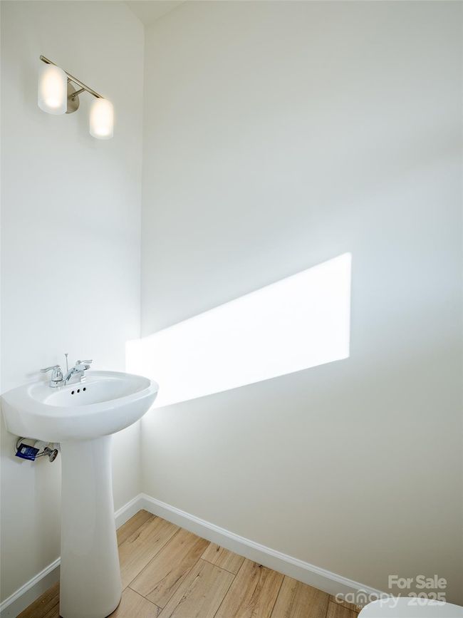 Guest powder room on main level at entrance - Photo is representational | Image 9