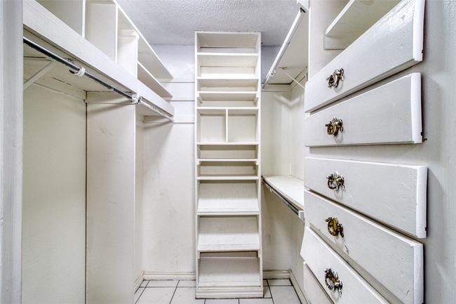 Walk in closet featuring light tile patterned floors | Image 11