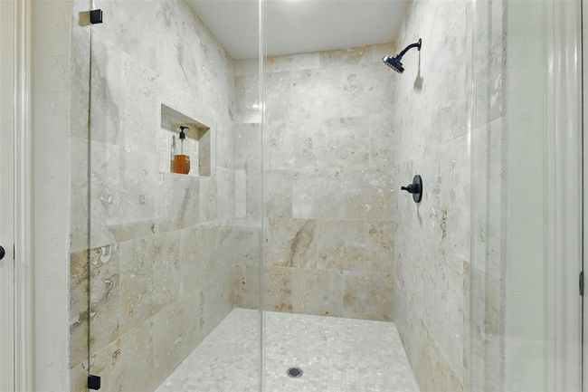 The oversized primary shower was recently remodeled in 2025 with tile surround and a seamless glass door. | Image 19