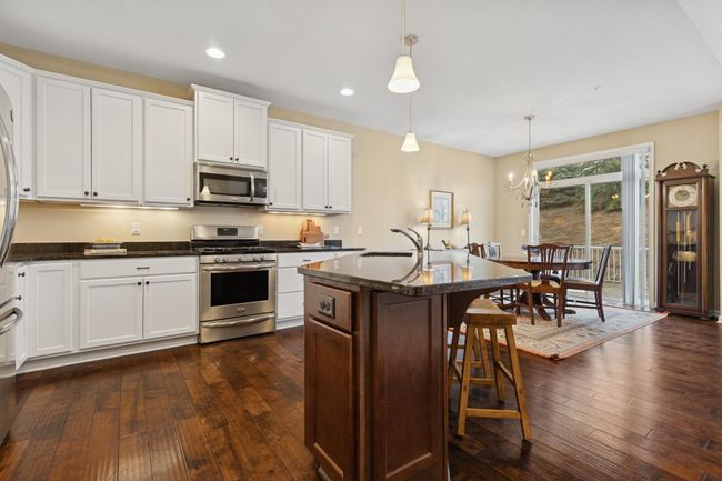 Center island plus SS appliances with gas range & granite throughout. Both function & beauty! | Image 8
