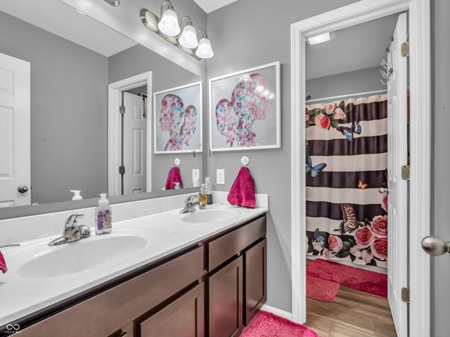 bathroom featuring double vanity. | Image 32