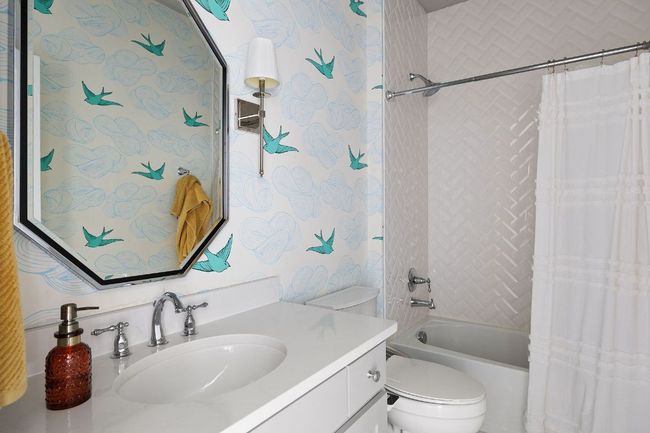Bathroom with shower / bathtub combination with curtain, vanity, and toilet | Image 34