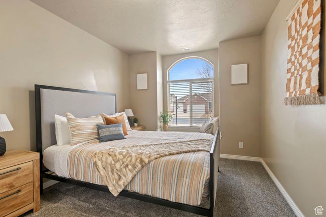 Carpeted bedroom with a textured ceiling | Image 17