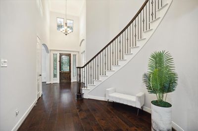 As you enter, you will be greeted by the soaring two-story ceiling that is sure to make you fall in love.The grand staircase invites you to explore the upstairs haven, setting the tone for the elegance and spaciousness found throughout this home. | Image 3