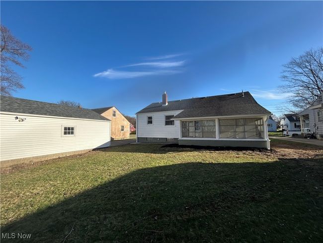 Back of property with a chimney, a yard, and a sunroom | Image 30