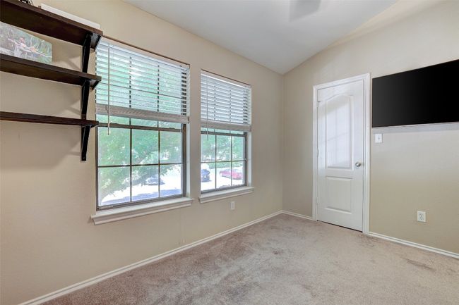 Carpeted empty room featuring lofted ceiling and baseboards | Image 28