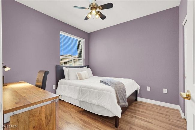 Bedroom with baseboards, ceiling fan, and light wood-style flooring | Image 24