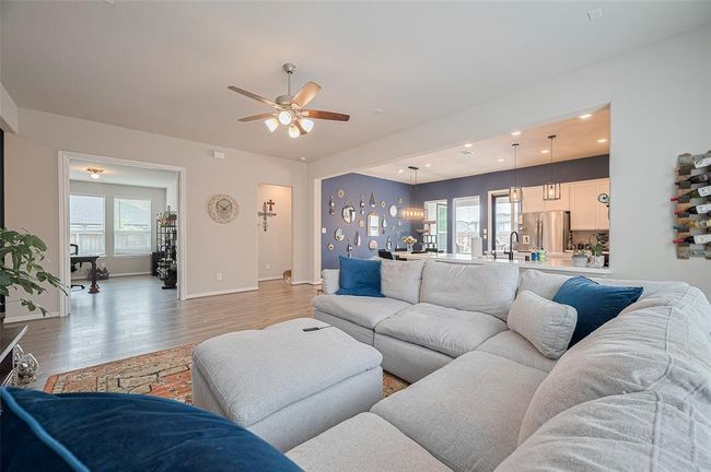 View from corner living room with view of over-sized study with French doors and open kitchen and breakfast area. | Image 18