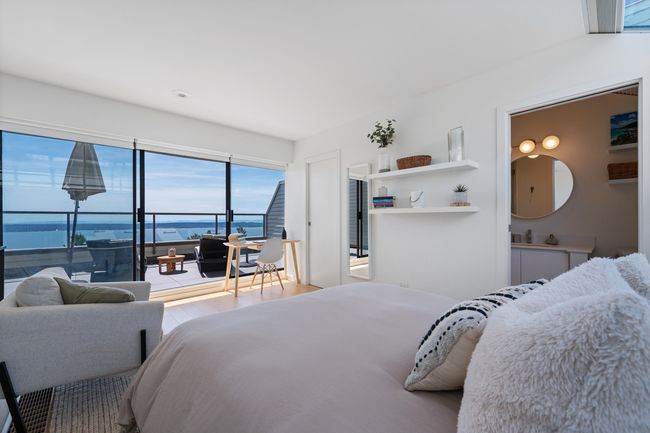 Bedroom with a water view, access to outside, and wood finished floors | Image 10