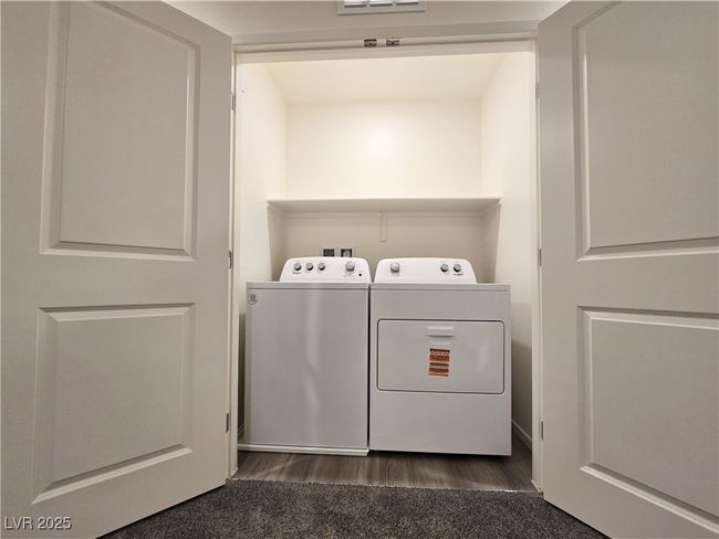 Laundry room featuring washer and clothes dryer and dark wood-style flooring | Image 18