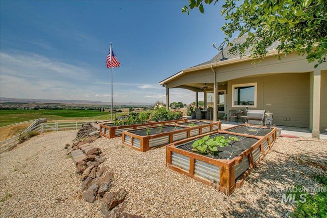 View of yard with a ceiling fan and a garden | Image 39