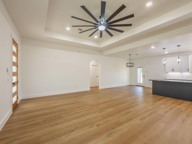 A beautiful blend of natural elements and clean lines greet you at the front entry. The frosted glass panel front door and large windows bring warmth and style into the space. | Image 10